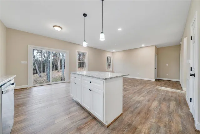 a kitchen with granite countertop white cabinets and stainless steel appliances