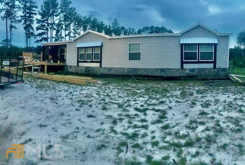 200 Sam Houston Road Folkston, GA 31537 - Photo 1 of 1 a front view of a house with garden