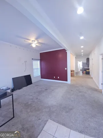 a view of a livingroom with furniture and a ceiling fan