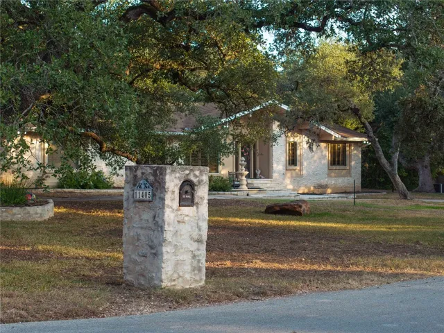 a view of a house with large trees