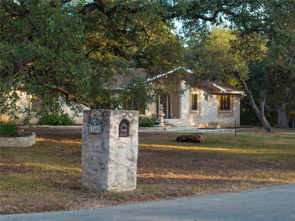 a view of a house with large trees