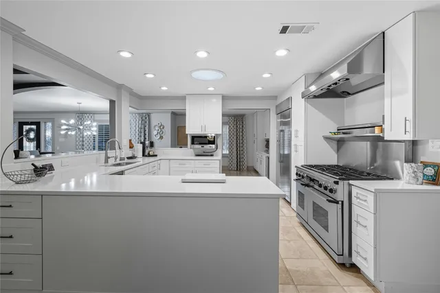 a kitchen with kitchen island a sink stainless steel appliances and cabinets
