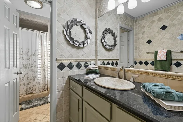 a bedroom with a bed mirror tv and a window