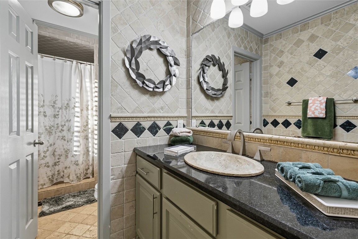 11405 Antler Lane Austin, TX 78726 - Photo 14 of 29 a bathroom with a granite countertop sink and a mirror