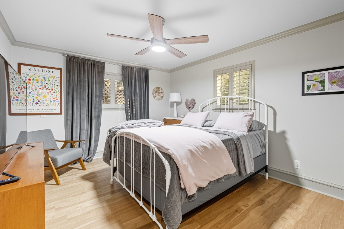 11405 Antler Lane Austin, TX 78726 - Photo 15 of 29 a bedroom with a bed and a chandelier