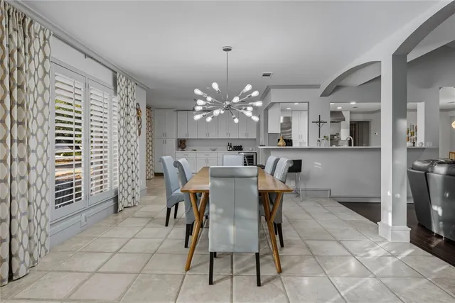 a view of a dining room with furniture and chandelier