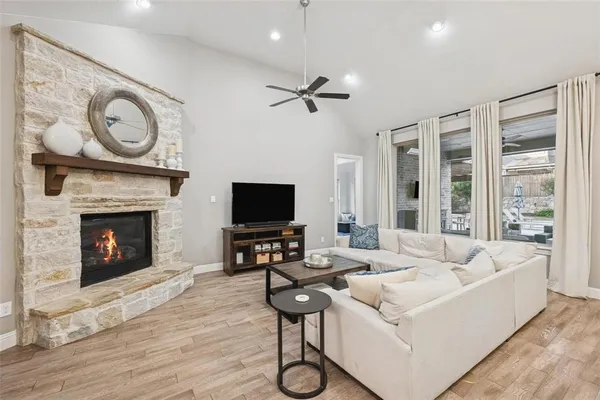 a living room with furniture a fireplace and a flat screen tv