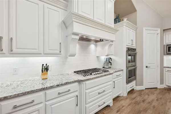 a kitchen with granite countertop cabinets and steel stainless steel appliances