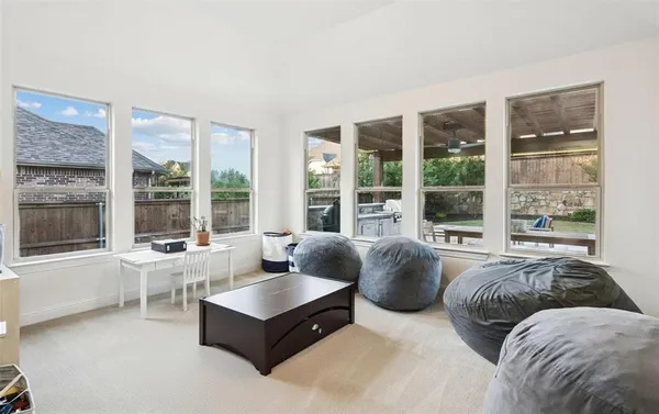 a living room with couches and a large window with outer view
