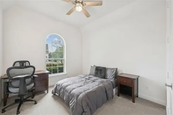 a bedroom with a bed and a table
