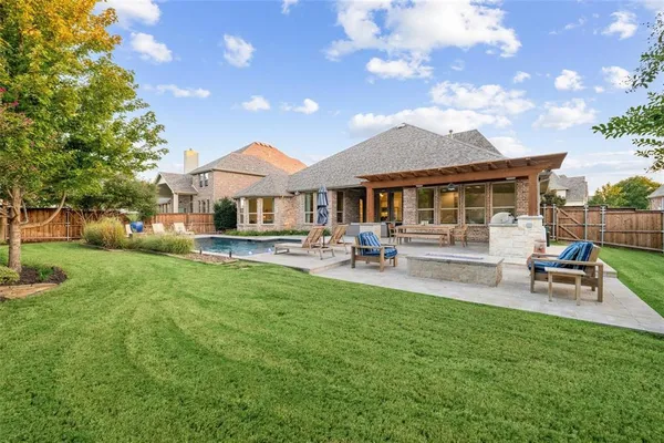 a swimming pool with outdoor seating and yard
