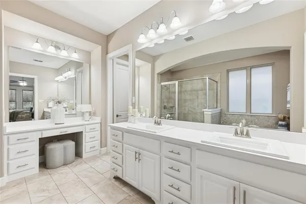 a spacious bathroom with a double vanity sink mirror and