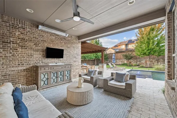 a living room with patio furniture and a flat screen tv