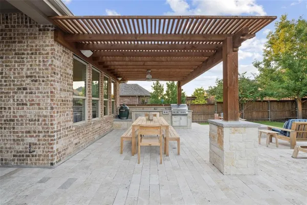 a view of a patio with table and chairs and wooden floor