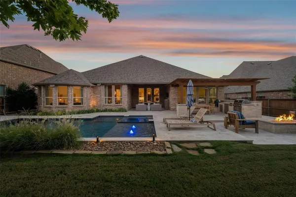 a front view of a house with swimming pool having outdoor seating