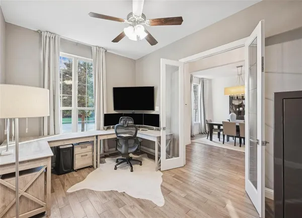 a view of a livingroom with workspace and a window