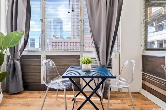 a view of a dining room with furniture and a window