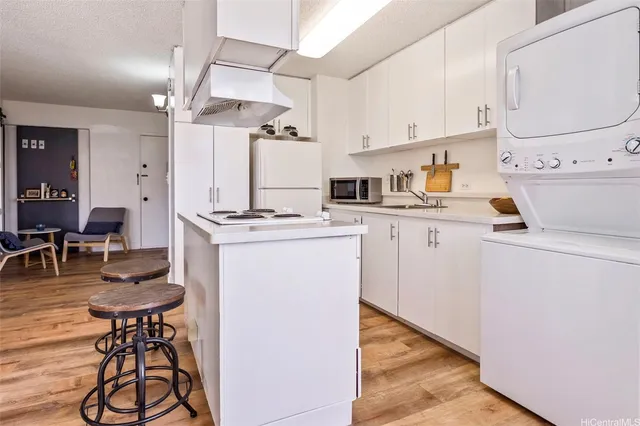 a kitchen with stainless steel appliances a stove a sink cabinets and a refrigerator