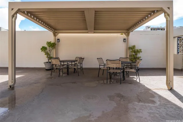 a view of dining room with furniture and potted plants