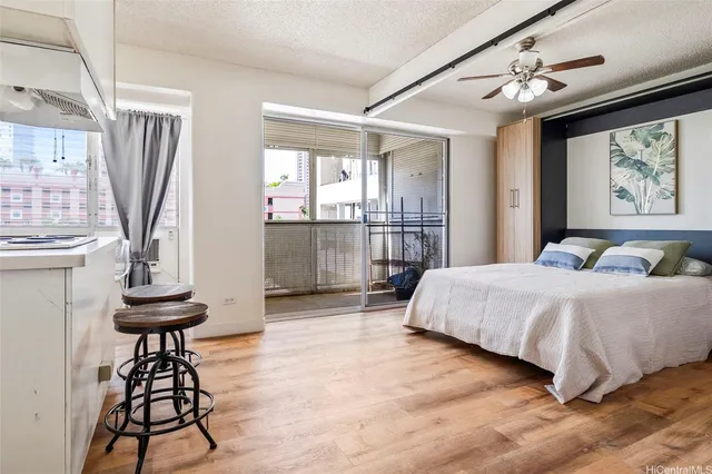a spacious bedroom with a bed and a chandelier