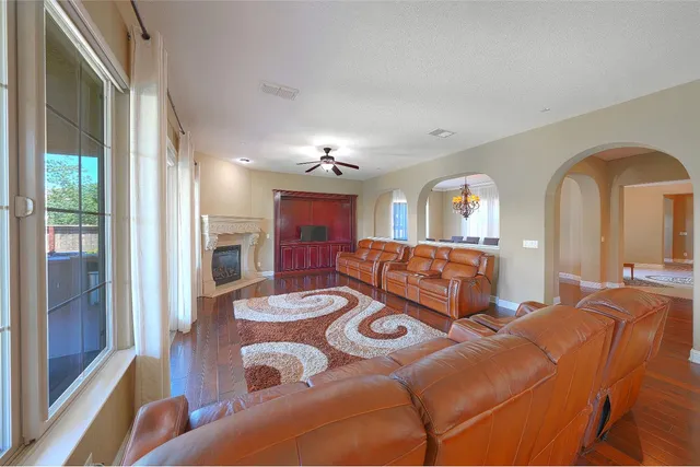 a view of a hallway with wooden floor and cabinet