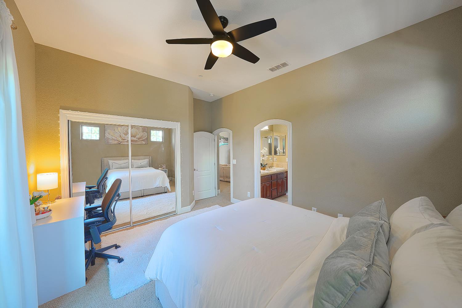 1340 Bella Circle Lincoln, CA 95648 - Photo 40 of 97 a bedroom with a large bed and a chandelier