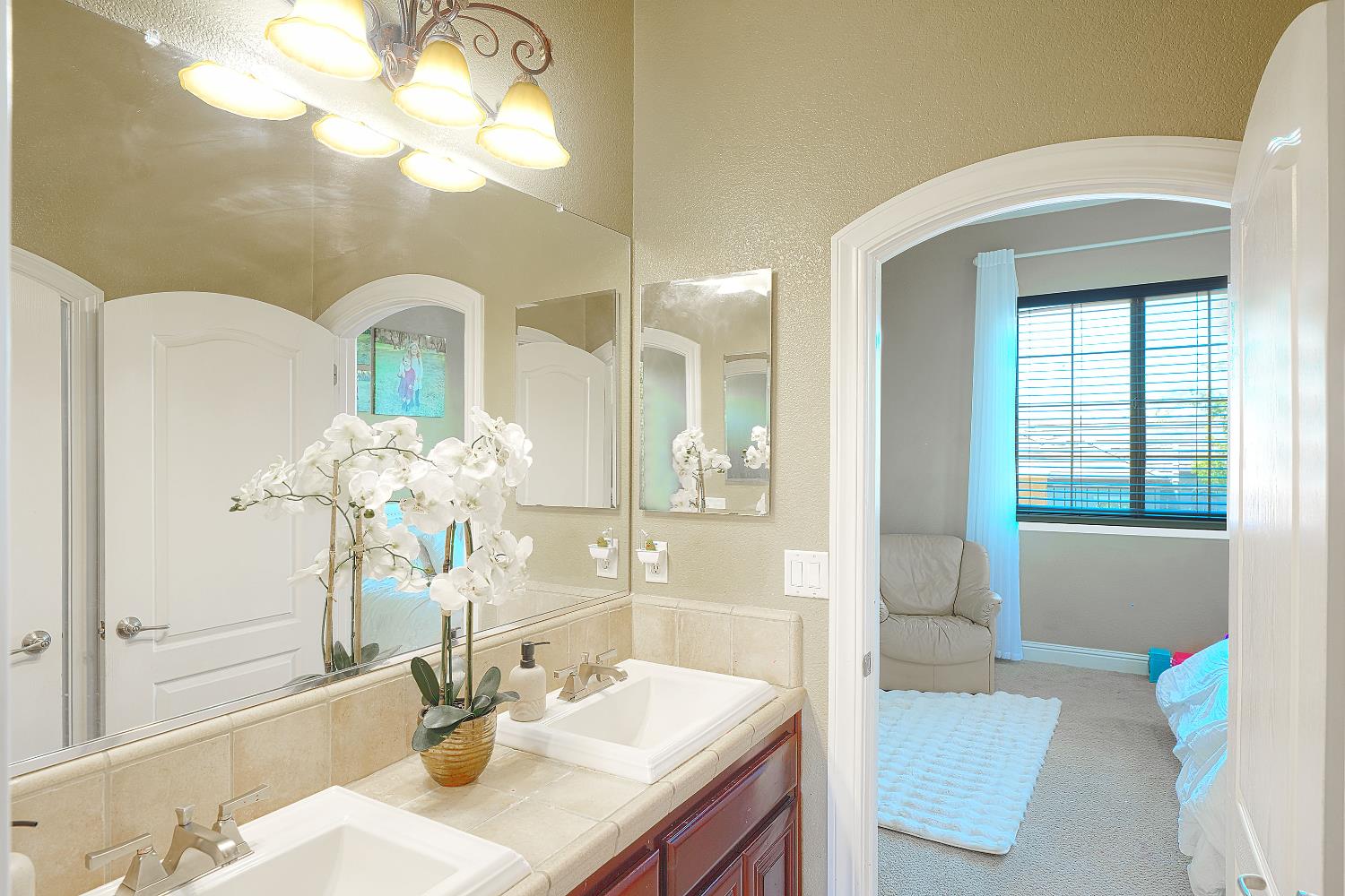 1340 Bella Circle Lincoln, CA 95648 - Photo 42 of 97 a bathroom with a granite countertop sink a large mirror and a bathtub