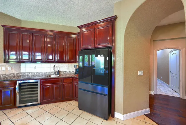 a bedroom with a large bed couch and windows