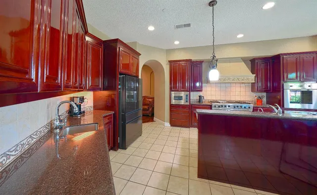 a spacious bedroom with a bed and ceiling fan