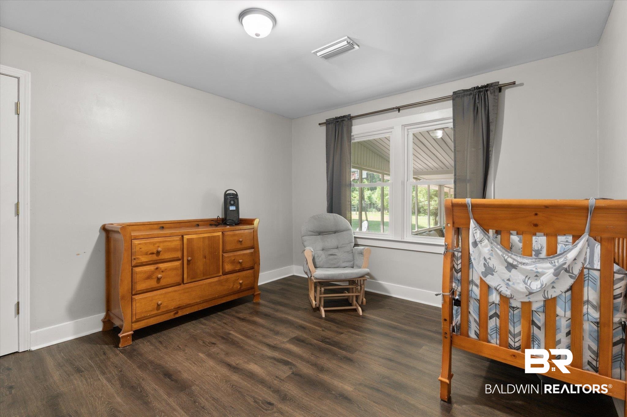 529 Cleveland Road Saraland, AL 36571 - Photo 21 of 31 Bedroom with dark wood-type flooring, visible vents, and baseboards