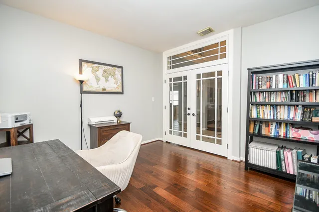 a view of a workspace with furniture and wooden floor