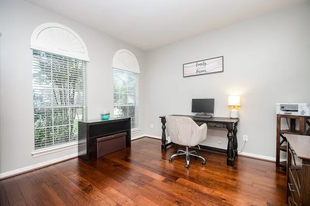 a view of a workspace with furniture and a window