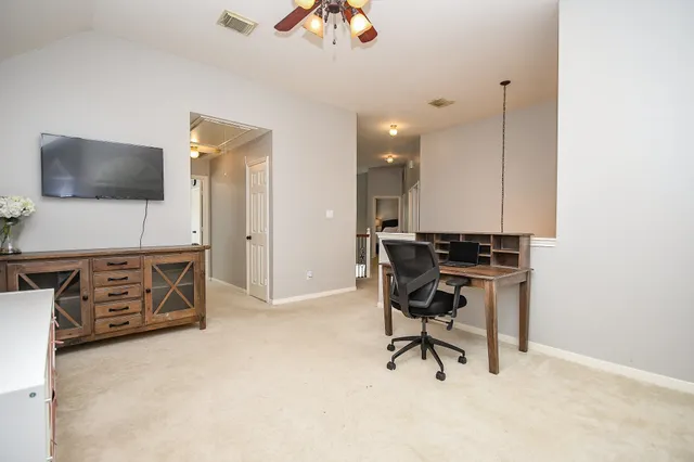 a workspace with furniture and a flat screen tv