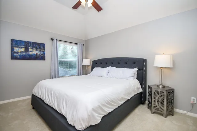 a bedroom with bed and window