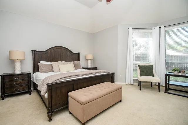 a bedroom with a large bed and a couch