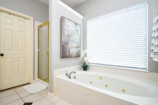 a bathroom with a bathtub and a shower