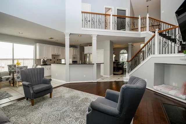 a living room with furniture and a dining table with kitchen view