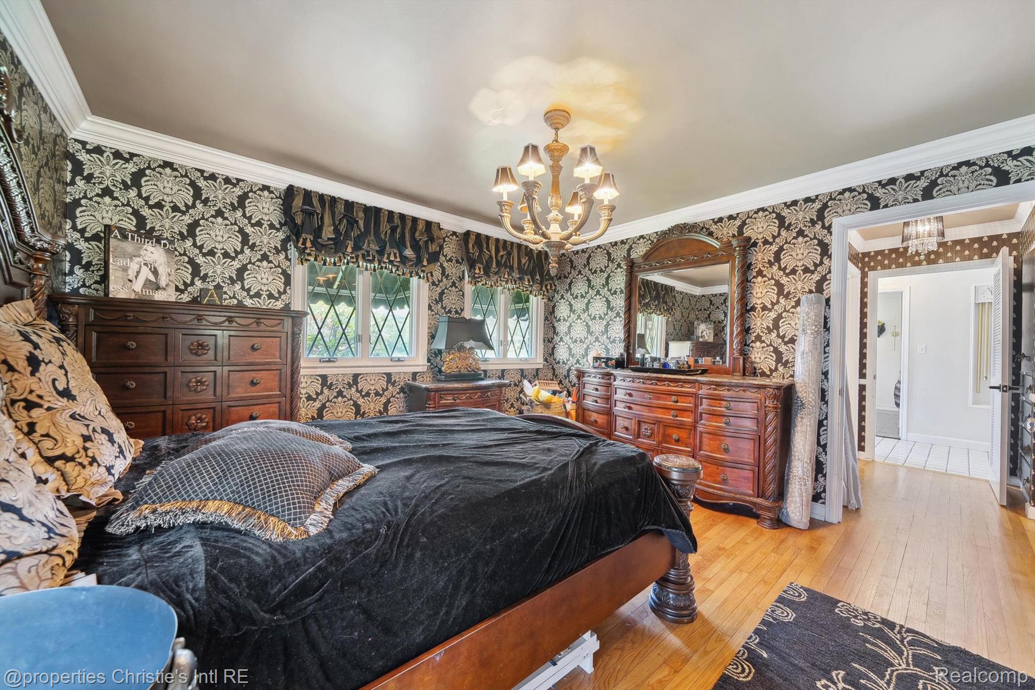 511 South Gulley Road Dearborn, MI 48124 - Photo 32 of 43 Hardwood flooring, ornate chandelier, decorative wallpaper, crown molding, and lattice windows