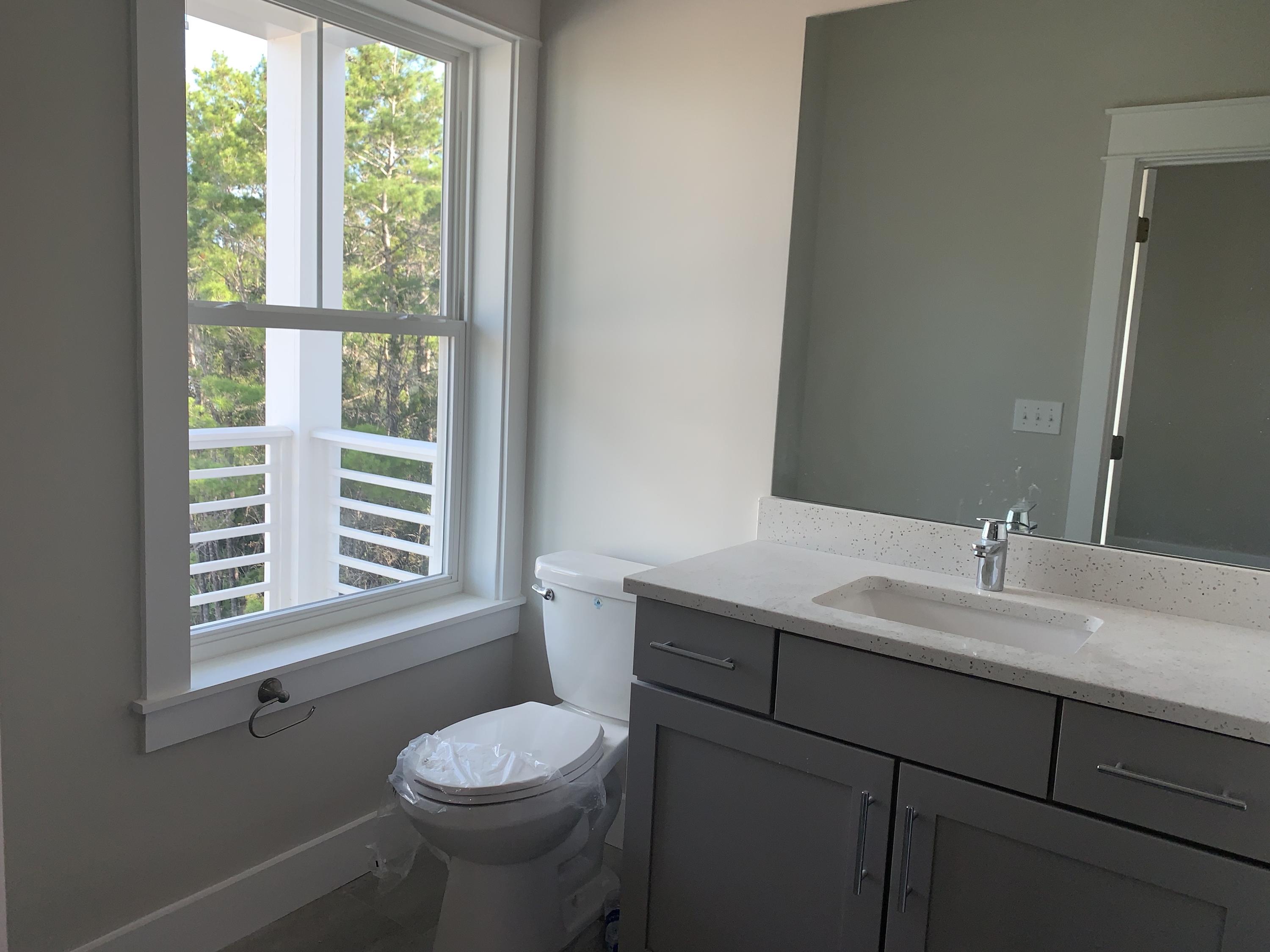 96 Beach View Dr Inlet Beach Inlet Beach, FL 32461 - Photo 12 of 13 a bathroom with a granite countertop sink toilet a mirror and window