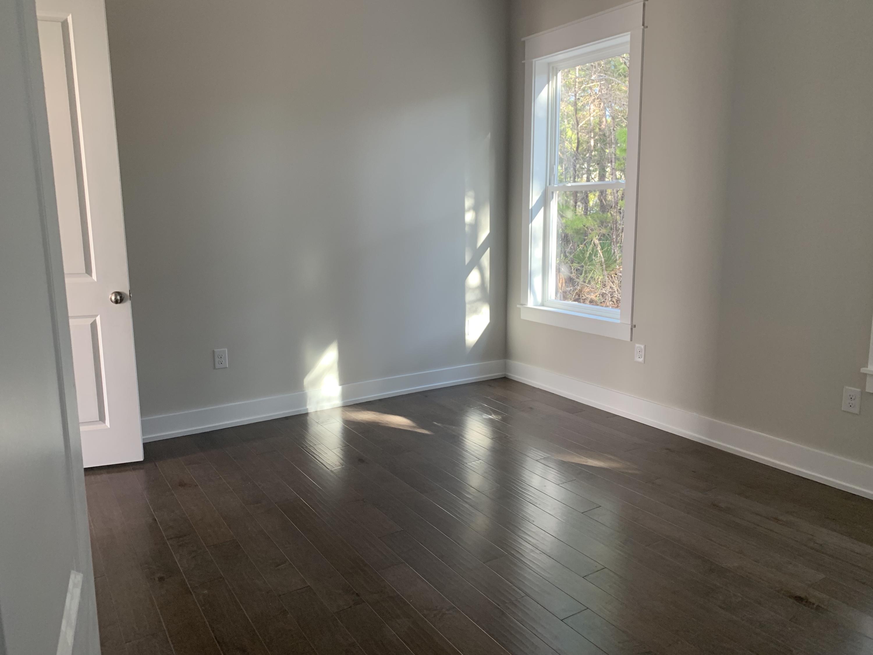 96 Beach View Dr Inlet Beach Inlet Beach, FL 32461 - Photo 6 of 13 an empty room with wooden floor and windows