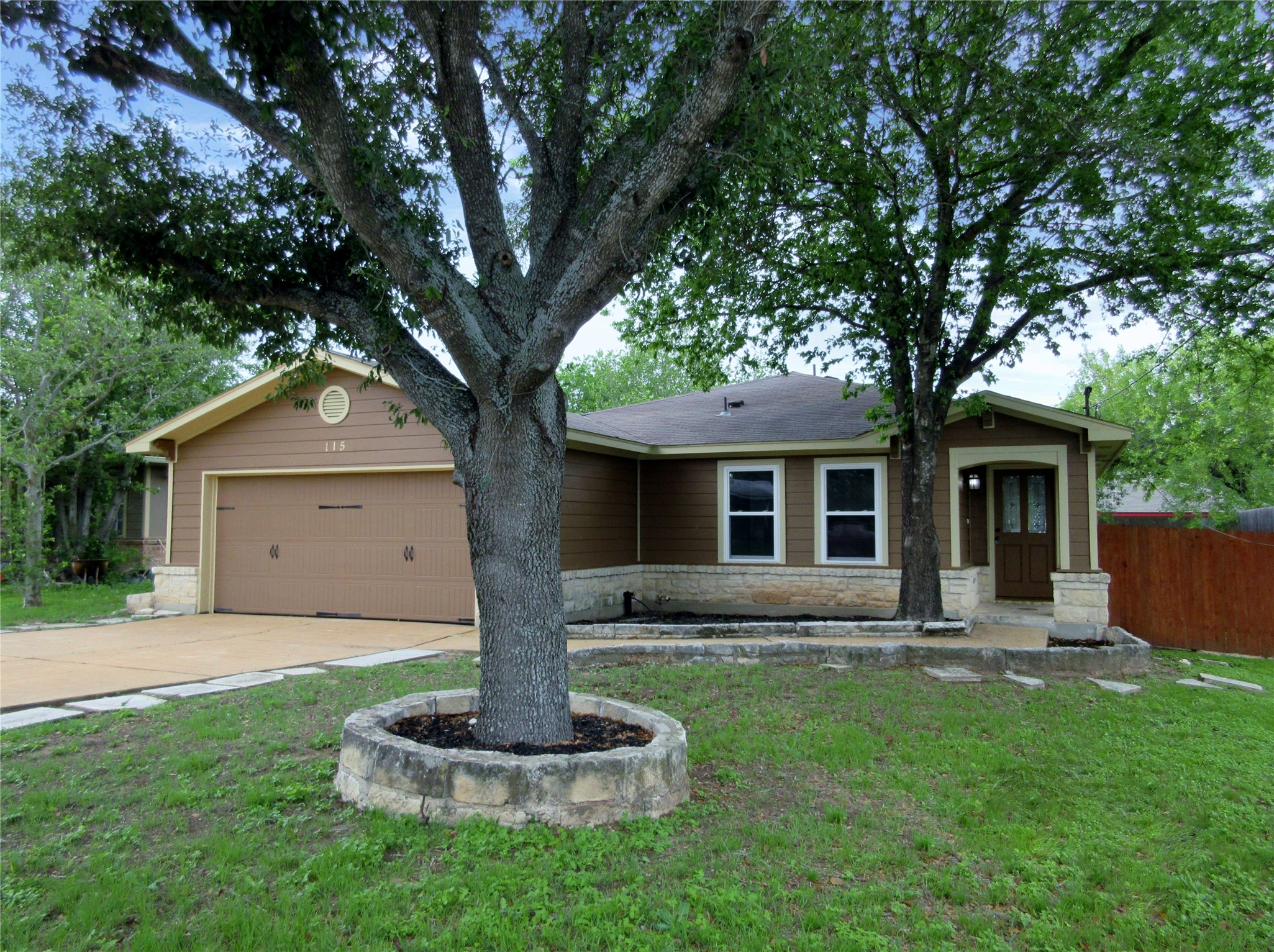 115 Rei Tang Loop Kyle, TX 78640 - Photo 1 of 17 a front view of house with a garden and trees