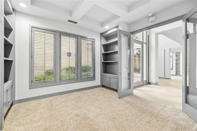 a view of an empty room with a fireplace and a window