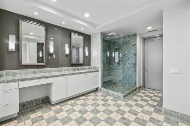 a bathroom with a mirror a sink and shower