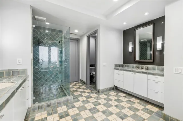 a bathroom with a sink a mirror and a shower