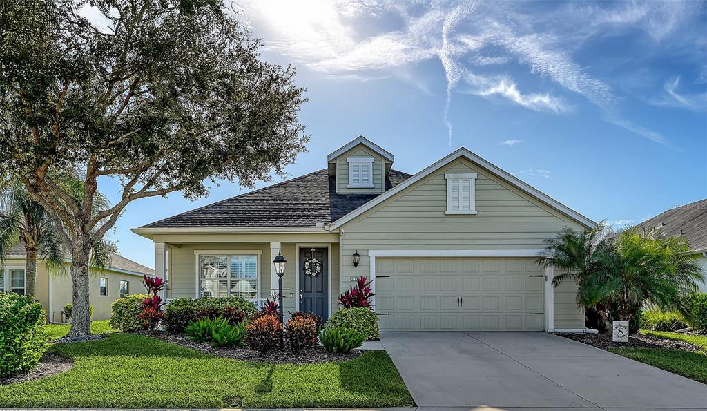 a front view of house with a garden