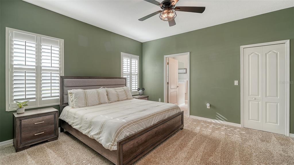 1318 Westover Avenue Parrish, FL 34219 - Photo 14 of 42 a bedroom with a bed and a chandelier