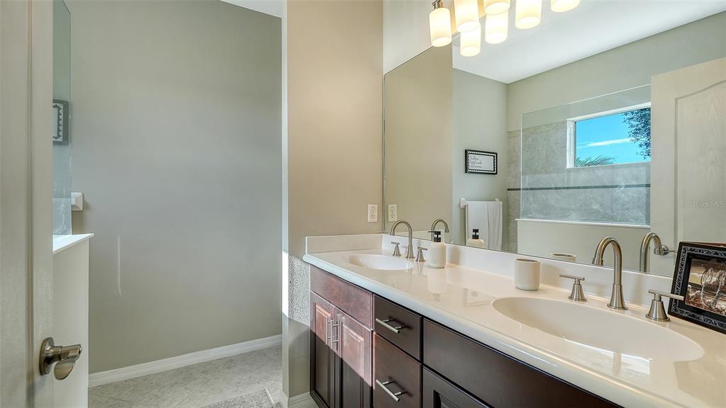 1318 Westover Avenue Parrish, FL 34219 - Photo 16 of 42 a bathroom with a double vanity sink and a mirror