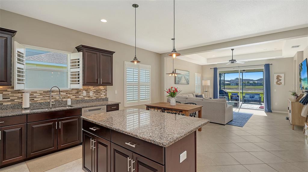1318 Westover Avenue Parrish, FL 34219 - Photo 8 of 42 a kitchen with stainless steel appliances granite countertop a sink a stove and a wooden cabinets