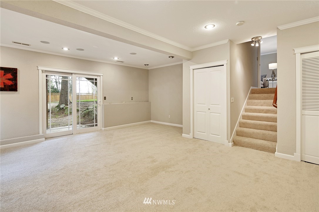 22415 1st Drive Southeast Bothell, WA 98021 - Photo 19 of 24 a view of an empty room with wooden floor and windows