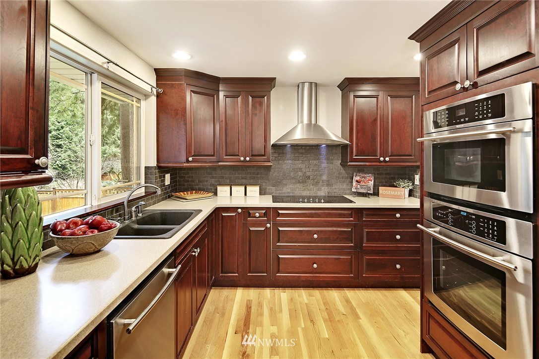 22415 1st Drive Southeast Bothell, WA 98021 - Photo 9 of 24 a kitchen with stainless steel appliances a stove sink and cabinets